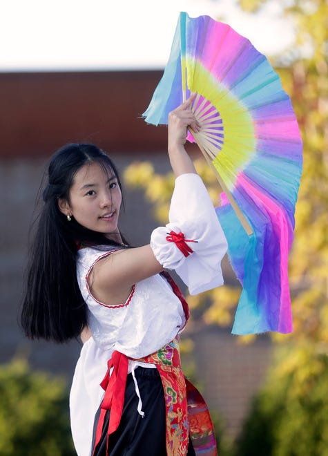 A dancer from New U performs for the audience during an Asian American, Pacific Islander heritage celebration at Green Bay Packers' Titletown District on May 15, 2024, in Ashwaubenon, Wis.