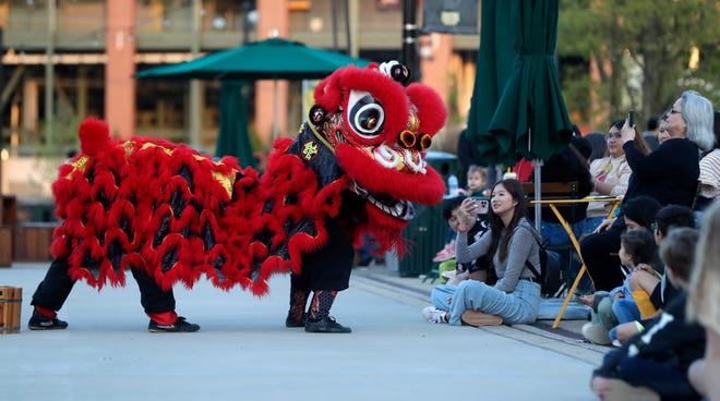 Dancers from Zhong Yi Kung Fu Association perform a Chinese lion dance for the audience during an Asian American, Pacific Islander heritage celebration at Green Bay Packers' Titletown District on May 15, 2024, in Ashwaubenon, Wis.