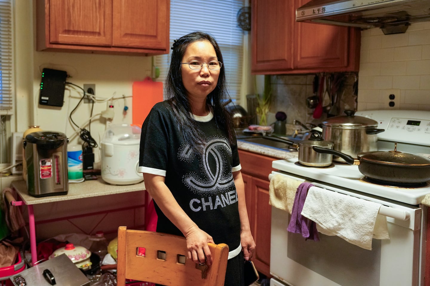 Xue Mei Ma inside her home on Oxford Street in Boston, where she lives  with her 13-year old son, her sister, and her niece.