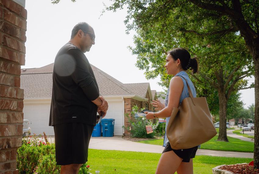 ROWLETT, TX - AUGUST 11, 2024: Averie Bishop, the Democratic candidate for Texas House District 112 and former Miss Texas, (right) speaks to a voter as she block walks in Rowlett, Texas on Sunday, August 11, 2024. CREDIT: Desiree Rios for The Texas Tribune**Asked not to be identified**