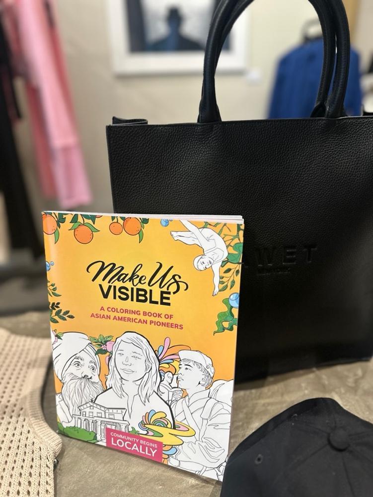 A book next to a bag
Description automatically generated