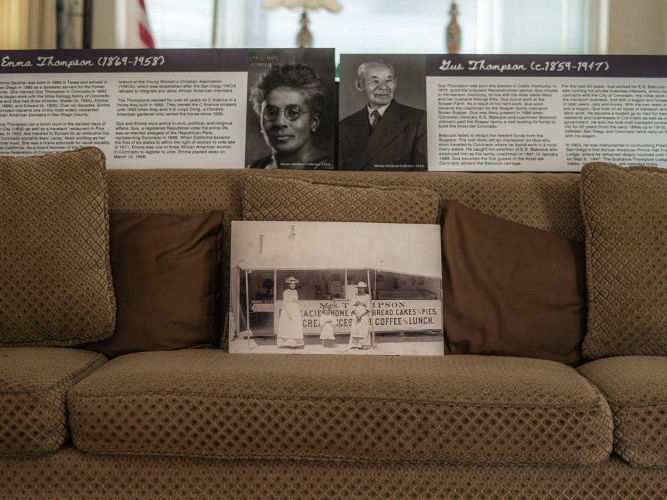 Portraits of Emma and Gus Thompson on display on a living room couch (Alan Nakkash for NBC News)