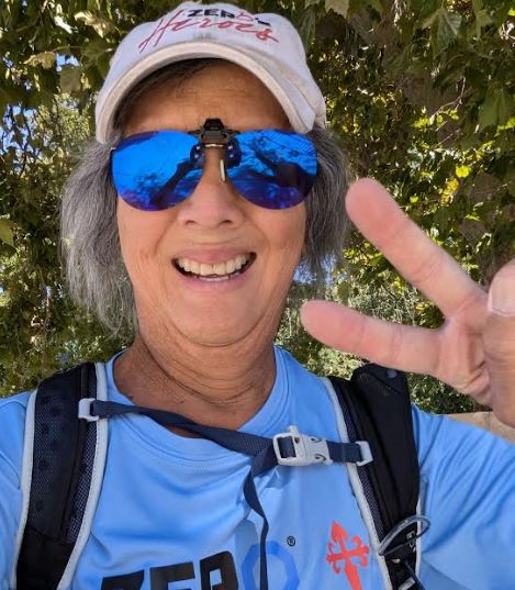 Randy Kam gives the victory sign as he strives to maintain positivity throughout his cancer treatments