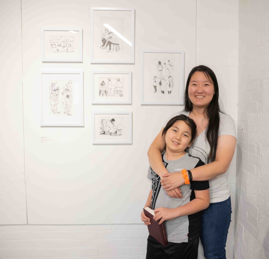 Dongjing Zhang Berglund poses with her son Gordon, 7, in front of her piece “People Studies,” 2023, Fountain Pen, Fude nib 55 degrees inked with Platinum Carbon Black, during the Dallas Asian American Art Collective’s first annual show at the Cedars Union Dallas on Saturday, Nov. 23, 2024.