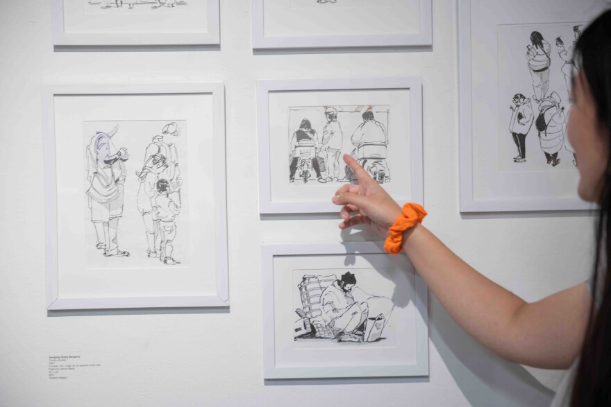 Dongjing Zhang Berglund talks about her piece “People Studies,” 2023, Fountain Pen, Fude nib 55 degrees inked with Platinum Carbon Black, during the Dallas Asian American Art Collective’s first annual show at the Cedars Union Dallas on Saturday, Nov. 23, 2024.