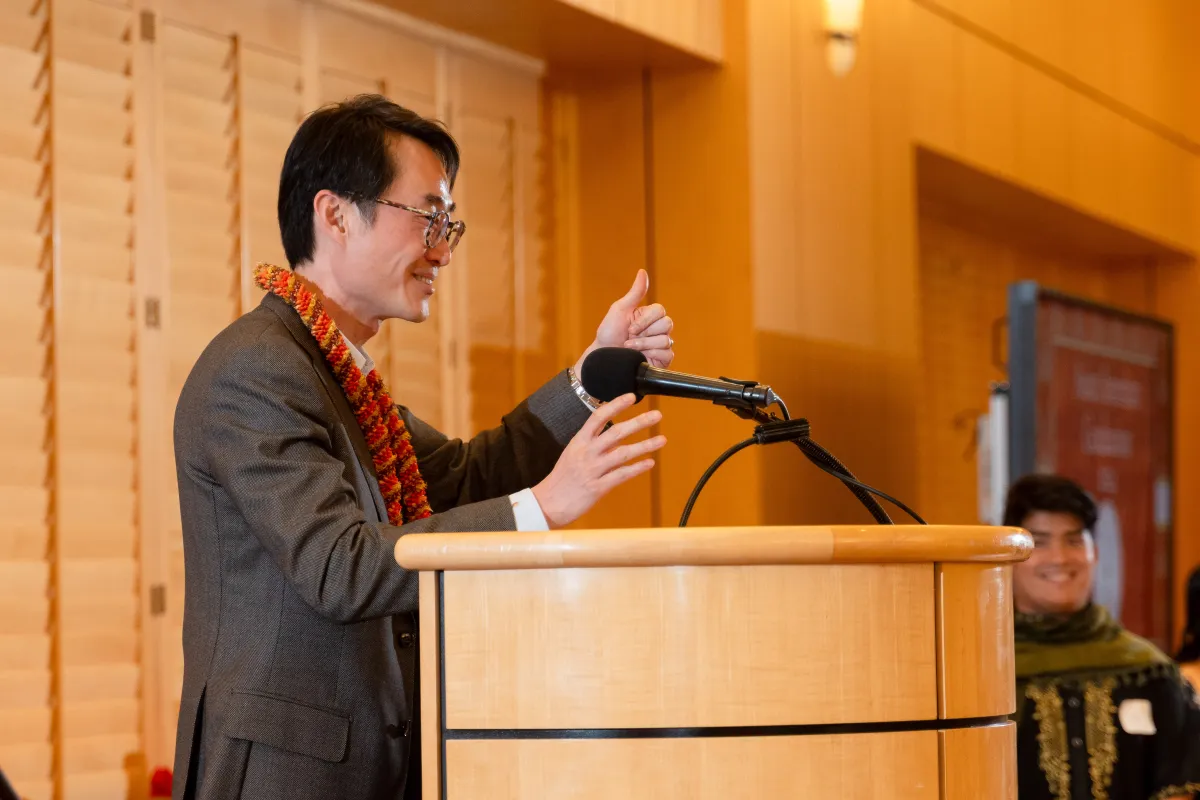 Will Hsu speaking in front of a podium