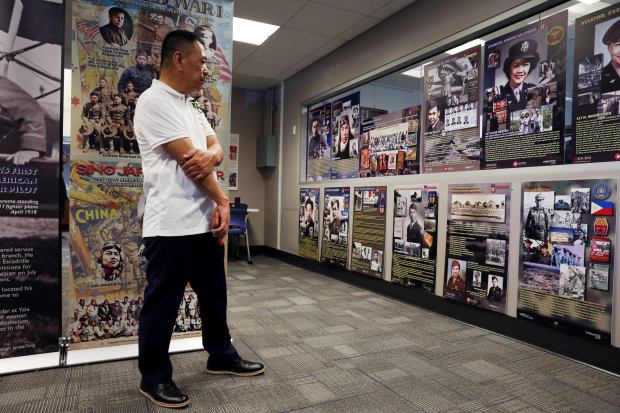 Andy Liu, of Monterey Park, studies a monthlong exhibit highlighting contributions of Asian Americans in the U.S. military during an unveiling event at Bruggemeyer Library in Monterey Park on Friday, July 3, 2026. The exhibit also serves as a celebration of America's 250th anniversary. (Photo by Trevor Stamp, Contributing Photographer)