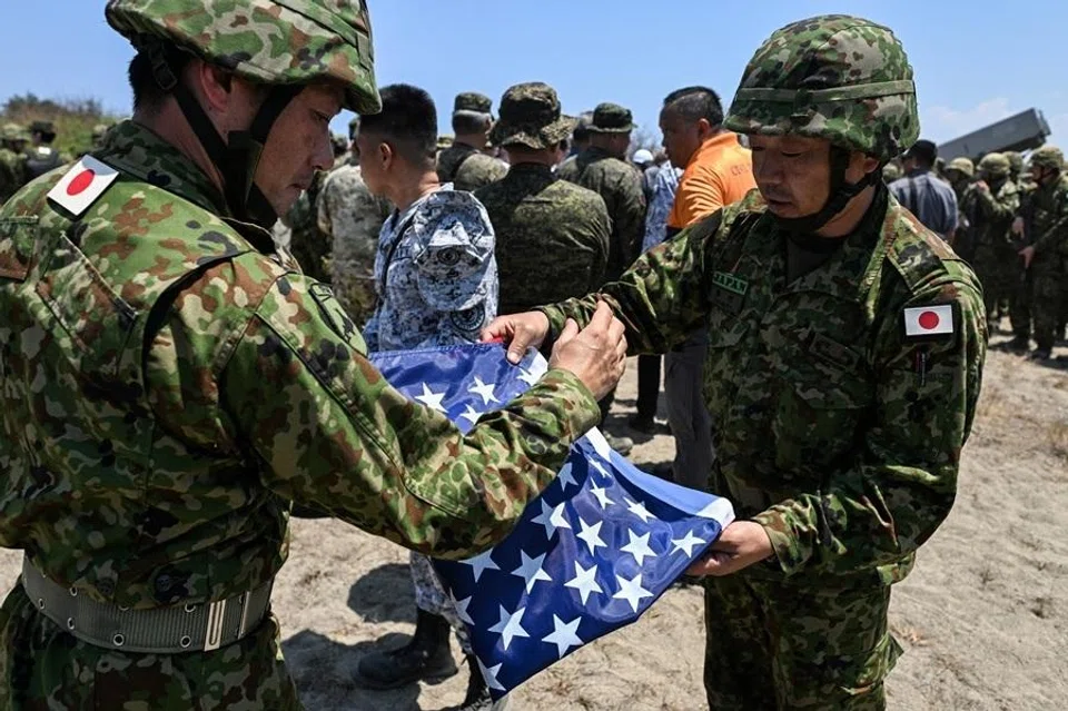 Japan Ground Self-Defense Force (JGSDF) soldiers fold a US flag during the Joint Task Force (JTF) Maritime Strike, part of Balikatan, the annual joint military exercises between the United States and the Philippines, at Culili Point Sand Dunes, Paoay, Ilocos Norte province, Philippines, on 6 May 2026.