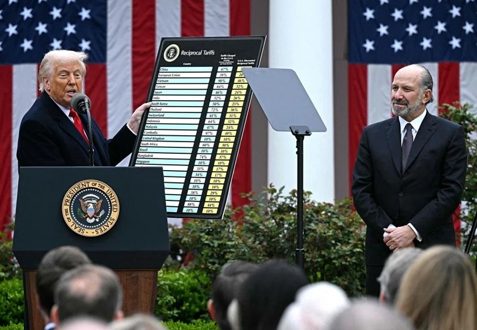 US President Donald Trump holds a chart as he delivers remarks on reciprocal tariffs alongside US Secretary of Commerce Howard Lutnick during an event in the Rose Garden entitled "Make America Wealthy Again" at the White House in Washington, DC, on 2 April 2025.