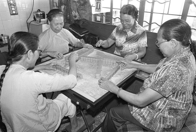 People play mahjong at Cho Yiu Chuen, public housing in Hong Kong, on July 13, 1979.
