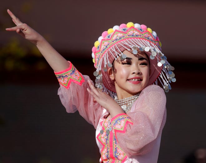 A dancer from Nkauj Zaj Dance Academy performs for the audience during an Asian American, Pacific Islander heritage celebration at Green Bay Packers' Titletown District on May 15, 2024, in Ashwaubenon, Wis.