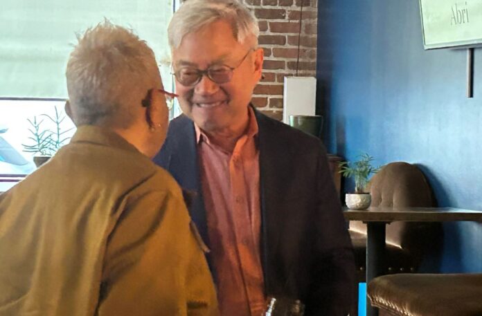 Retiring CAAM executive director Stephen Gong talks to a CAAM supporter