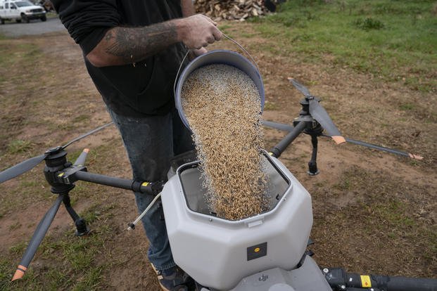 Russell Hedrick prepares a DJI drone to put crop cover on his farm