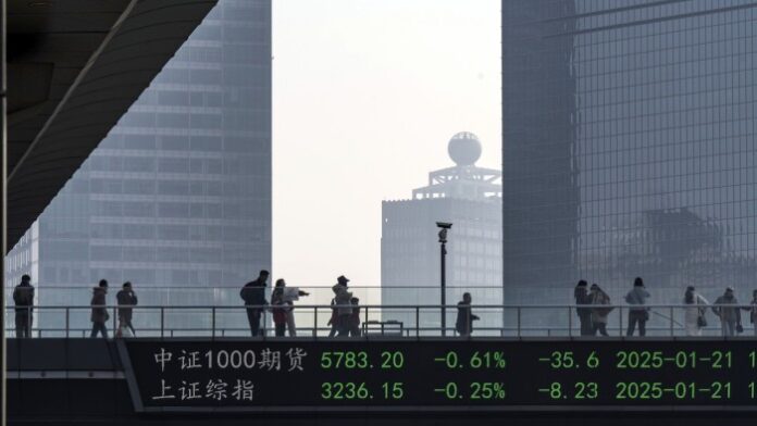 Pedestrians on a footbridge in Shanghai’s financial district