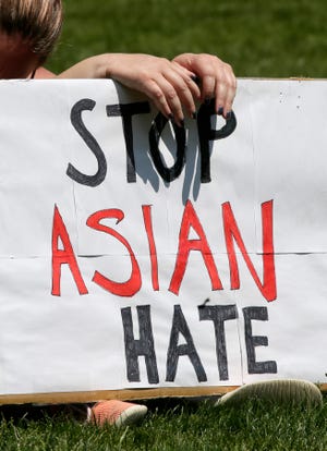 A woman holds a sign that reads, "Stop Asian Hate," during a rally for peace called Solidarity: Ohio United Against Hate at Bicentennial Park in downtown Columbus, Ohio, on Sunday, May 16, 2021.