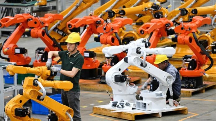 A worker assembles industrial robots at a production workshop of Nanjing Estun Automation in China’s eastern Jiangsu province