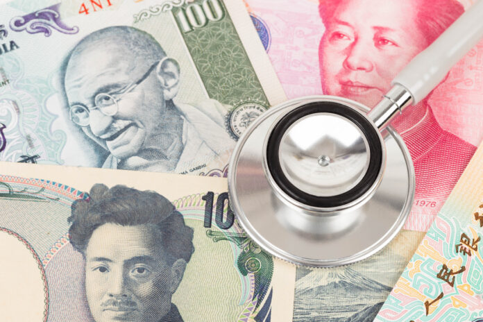 Stethoscope on asian banknote concept financial health check